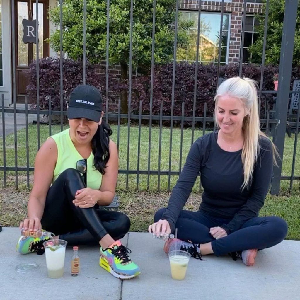 2 women making cocktails on the sidwalk