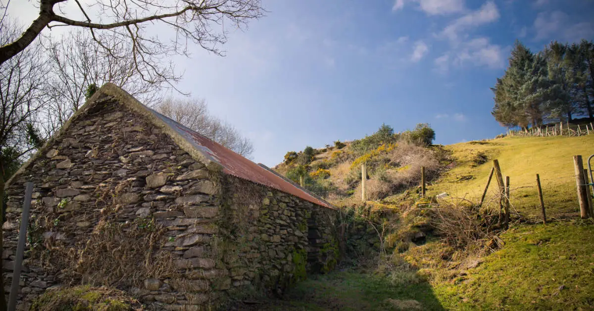 An old stone cabin an a hillside