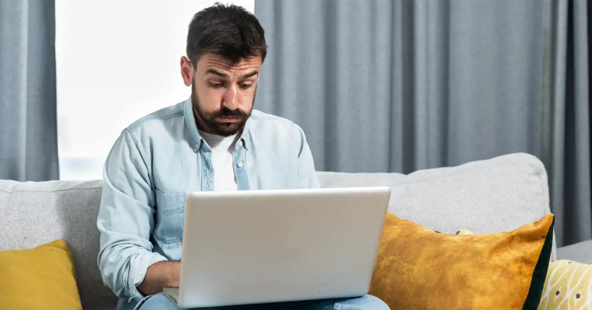 man frustrated working on laptop