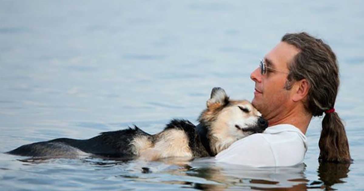 man floats with his dying dog