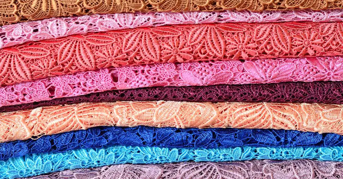 lace material of various colours stacked