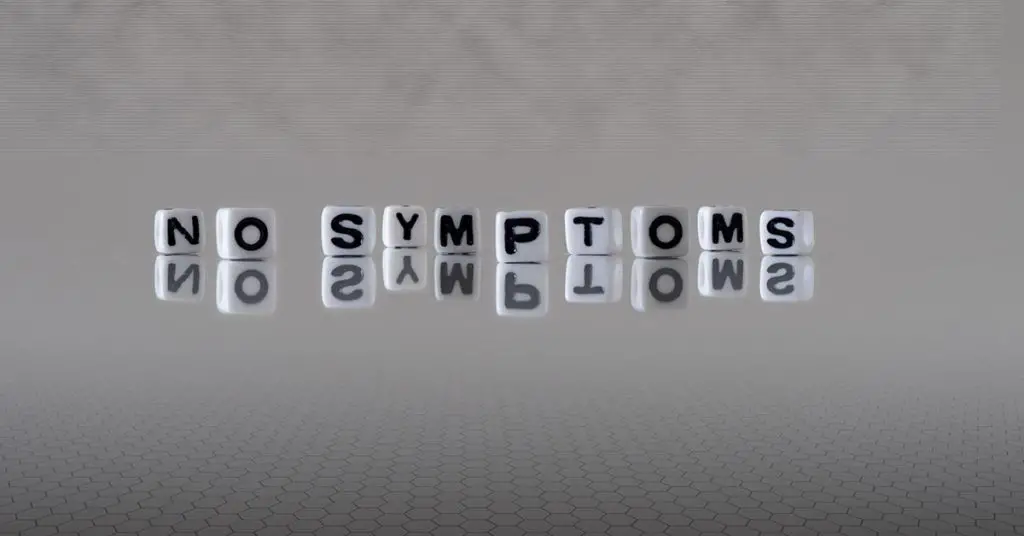 dice shaped white cubes spelling the phrase "no symptoms"