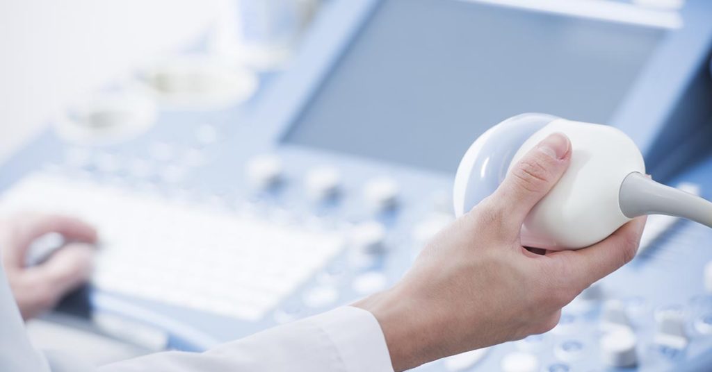 person holding ultrasound device