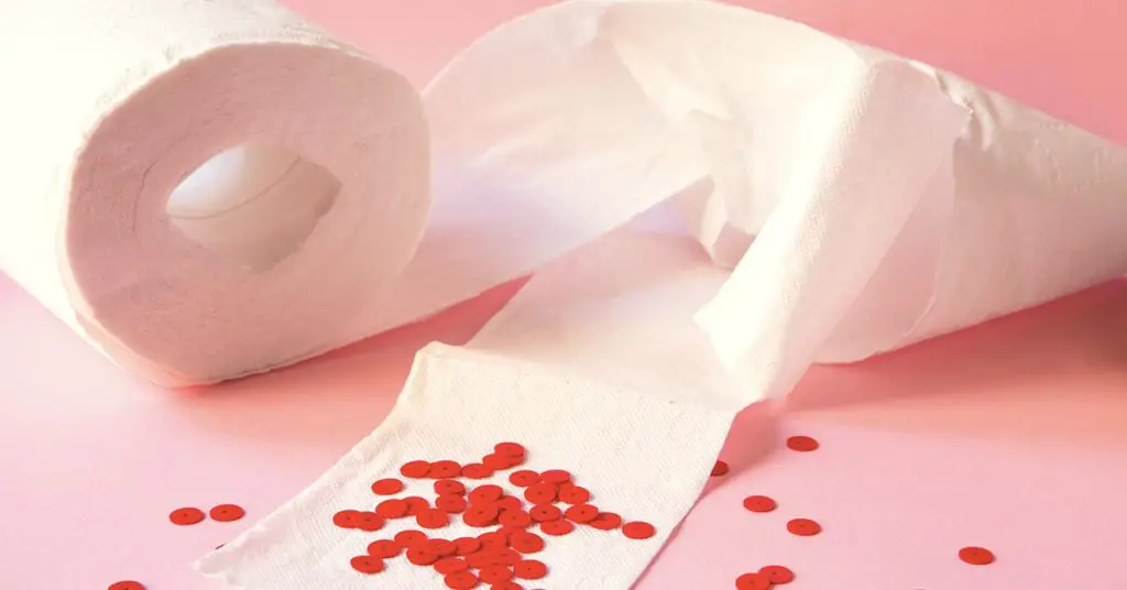 toilet paper with red paper dots depicting blood