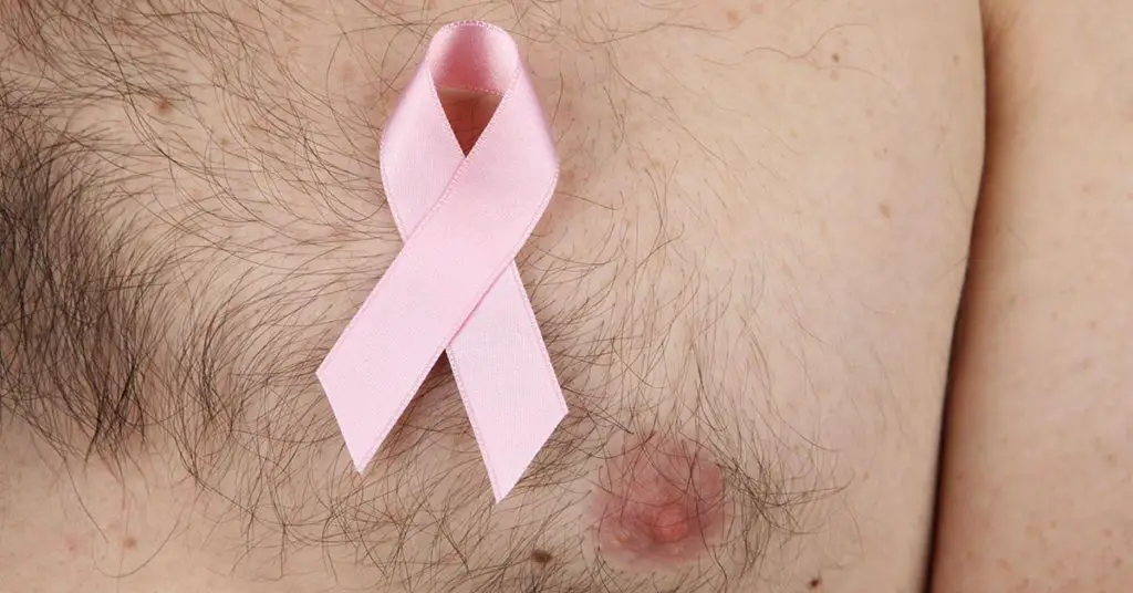 breast cancer ribbon on mans chest