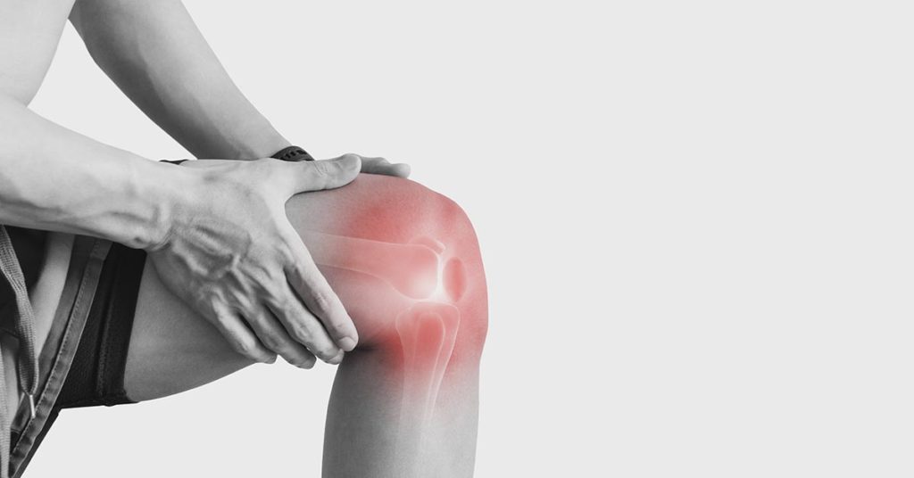person holding knee in pain
