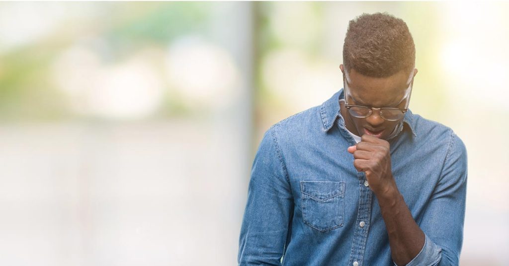 young man coughing