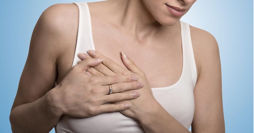 woman holding chest