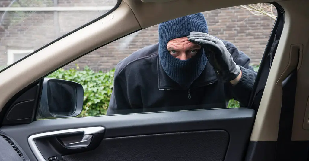 masked man peering in car