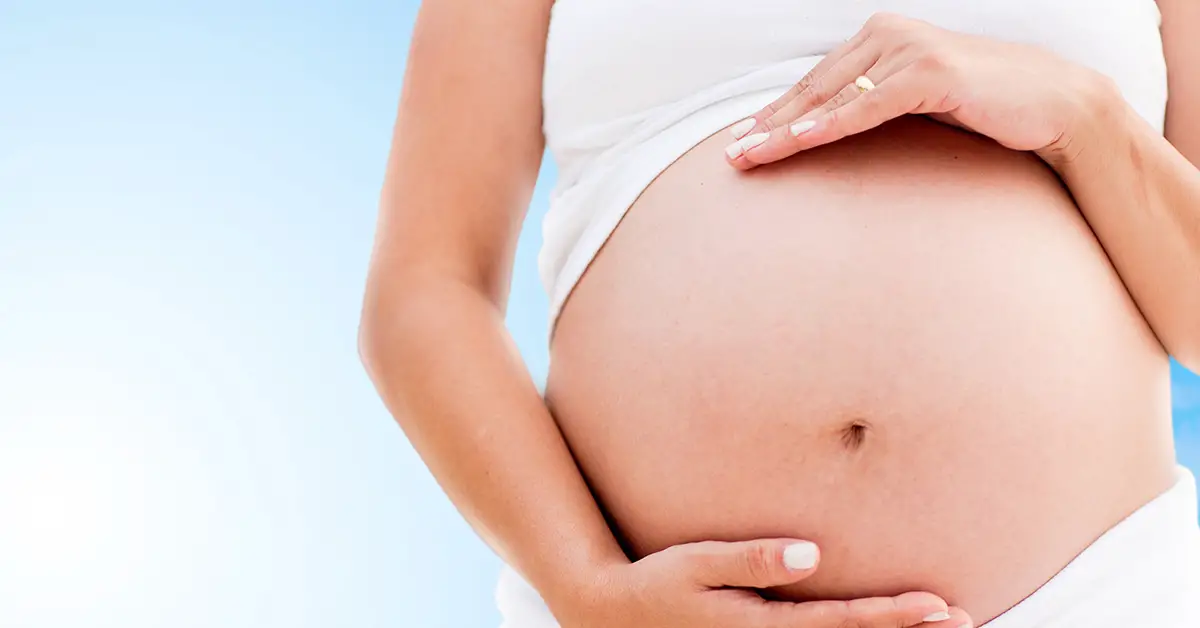 woman holding pregnant tummy