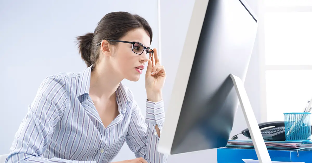 woman examining computer screen