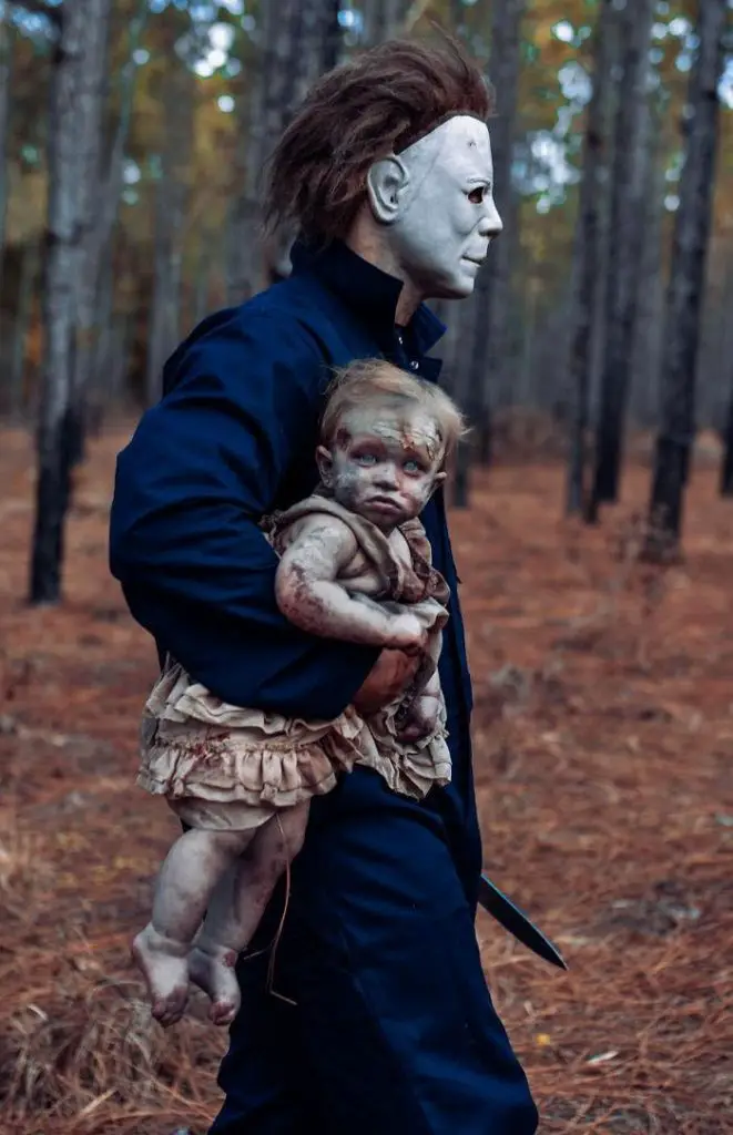 Halloween character Michael Myers holding a child