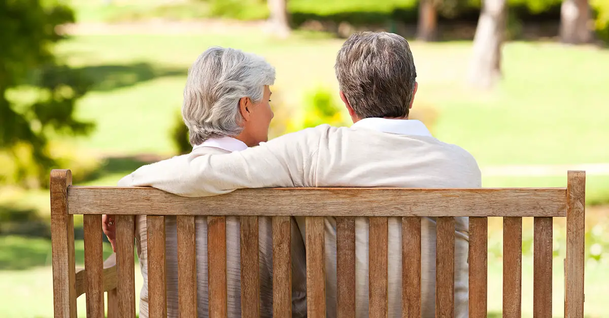 elderly couple sitting on a bench