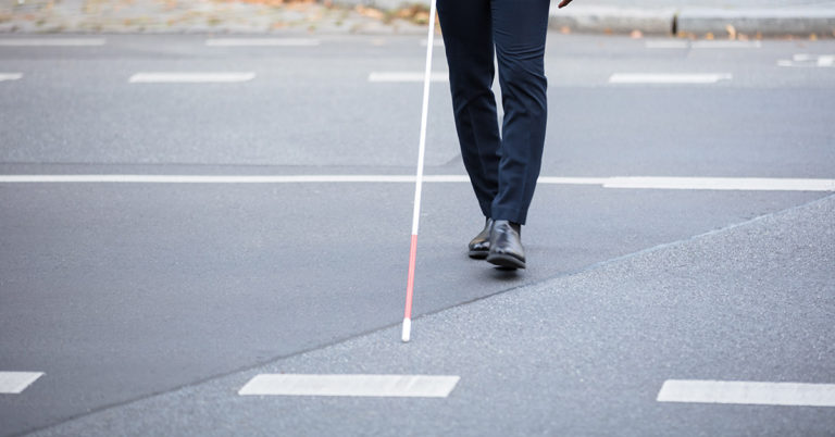 Young woman grabs blind man’s hand not knowing man from stands filming her - Featured image