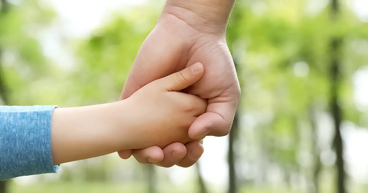 a child hand holding an adults