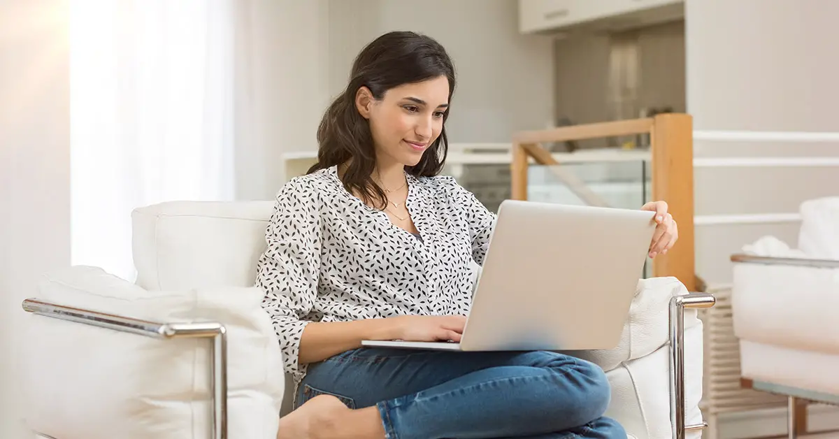 woman on couch using laptop