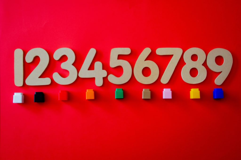 numbers 123456789 with small coloured plastic cubes beneath each number
