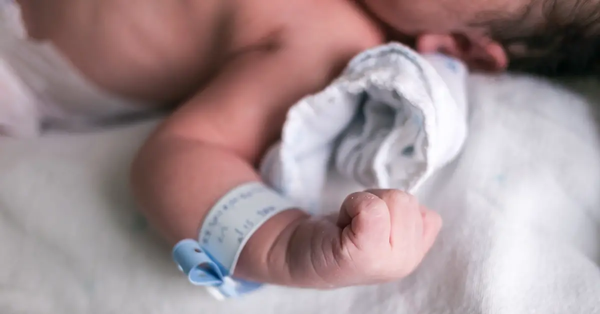 newborn wearing a hospital bracelet
