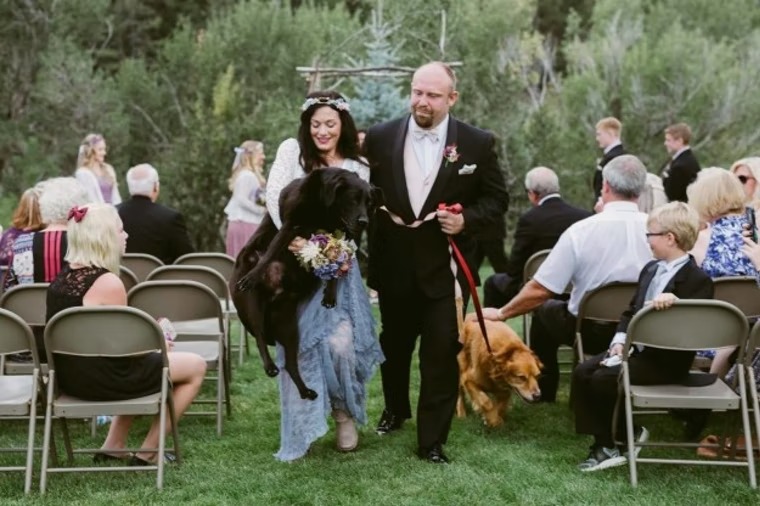 Katie Lloyd carrying Charlie Bear up the aisle