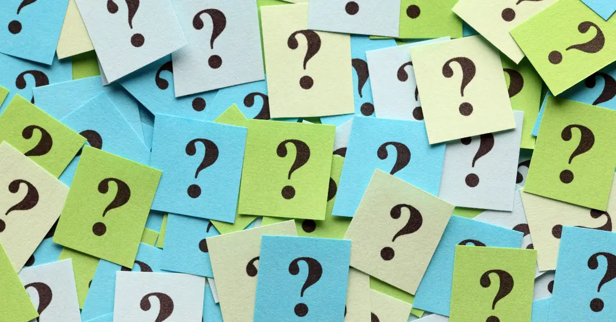 multiple blue, green and light yellow post-it notes with question marks on them