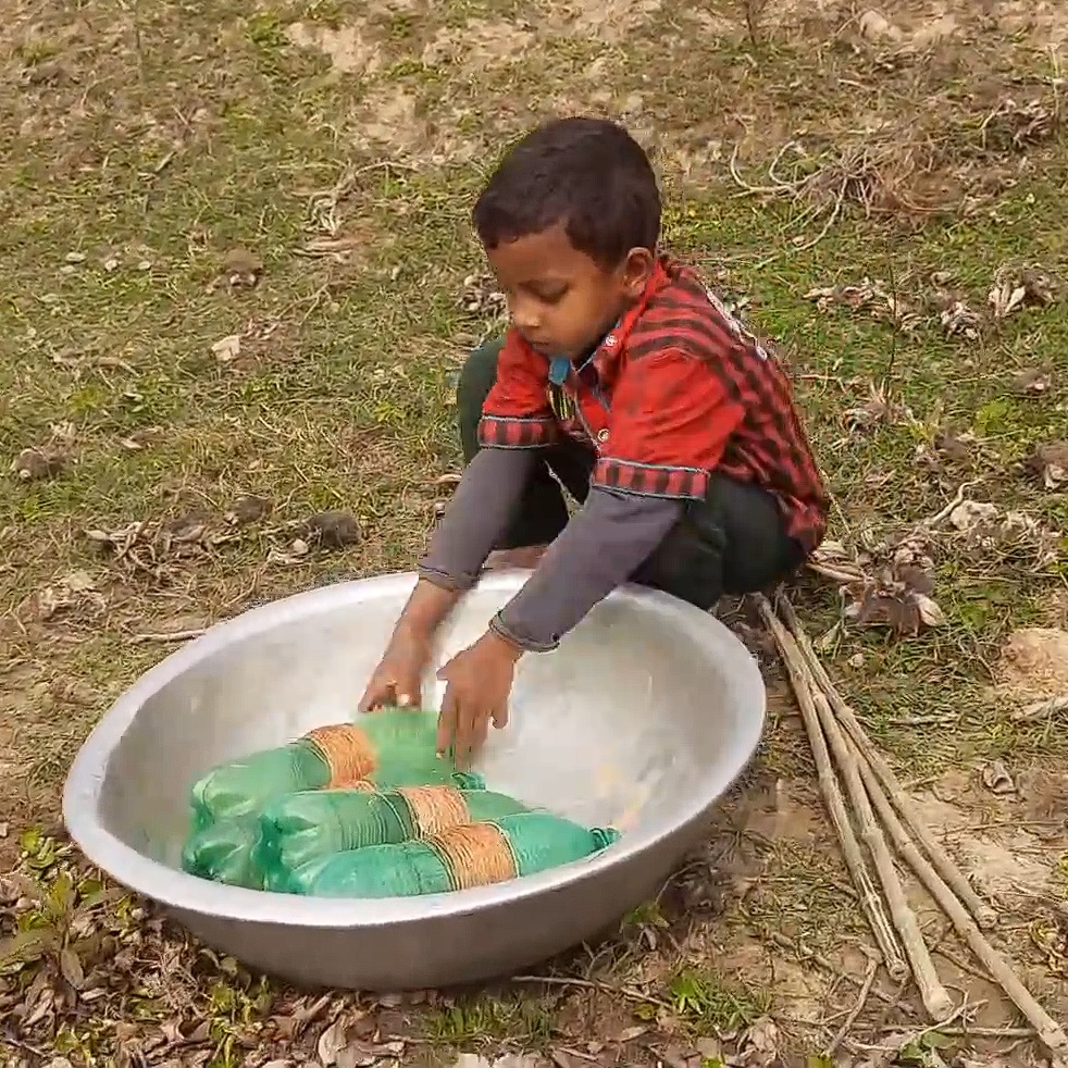 boy using plastic bottles as tools to fish