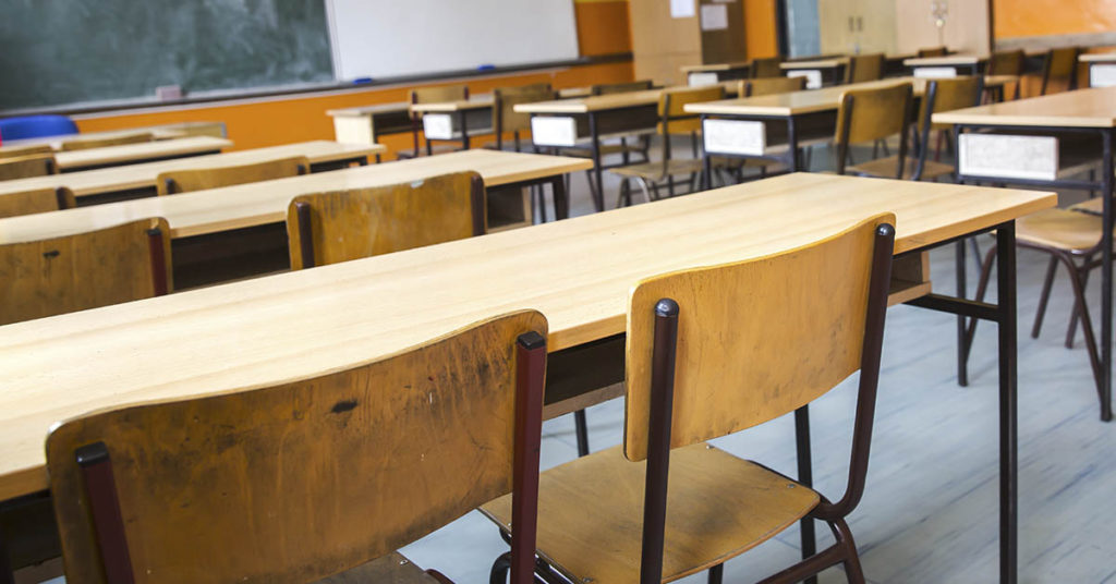 The reason one teacher has kept an empty chair in his classroom for 50 years - Featured image