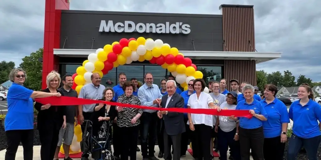 The staff cutting the ribbon at the re-opening of the Mayfields McDonad's Branch after renovation.