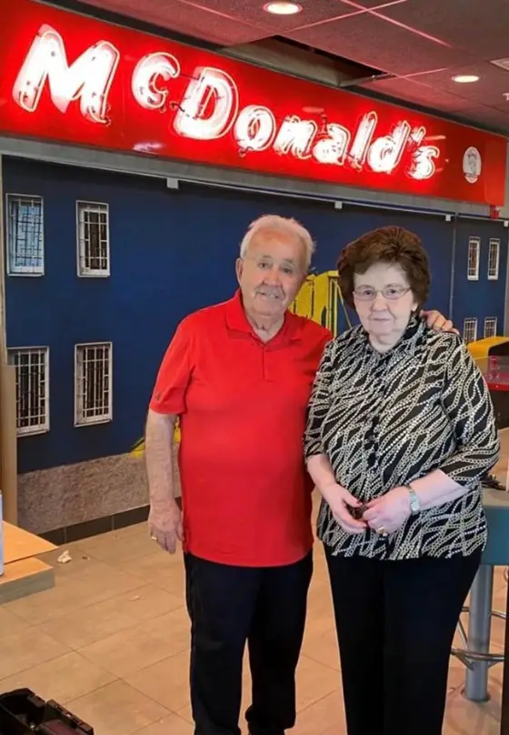 Tony Philiou and his wife posing inside their newly renovated McDonald's location