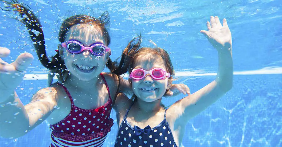 two children underwater in a pool