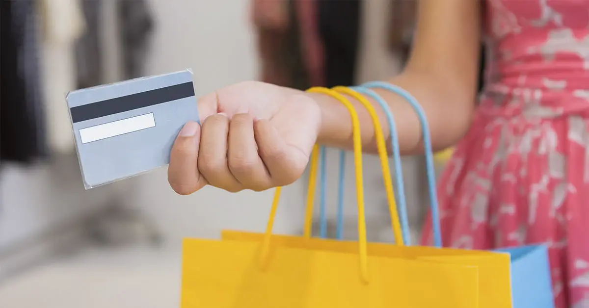 woman holding shopping bags and credit card