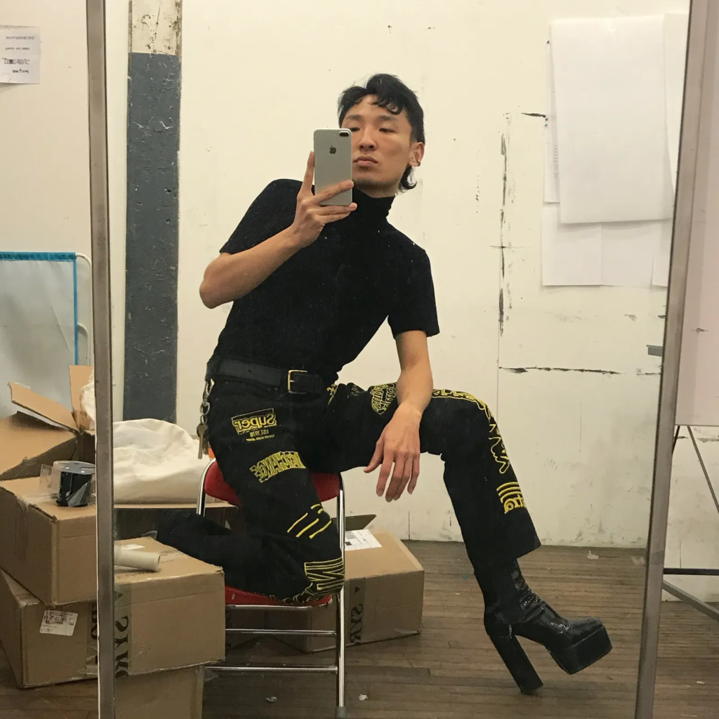 Shaobo Han wearing black heeled boots.