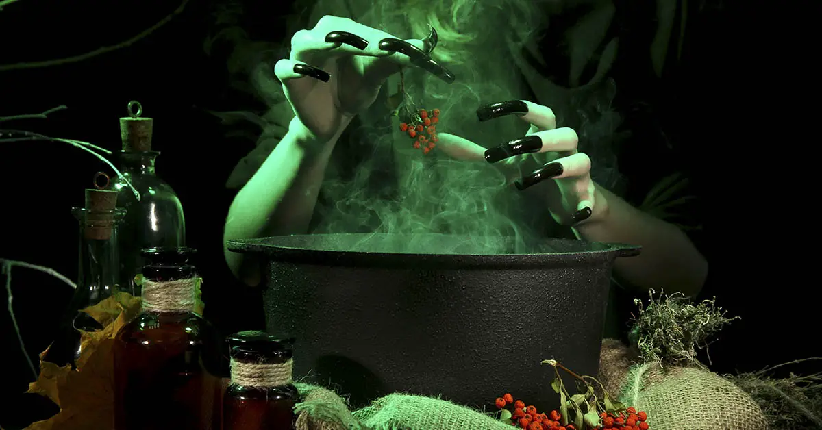 evil witch adding ingredients to cauldron