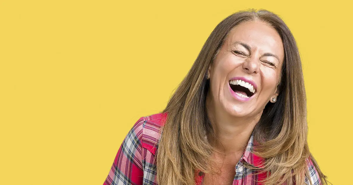 woman laughing, yellow background