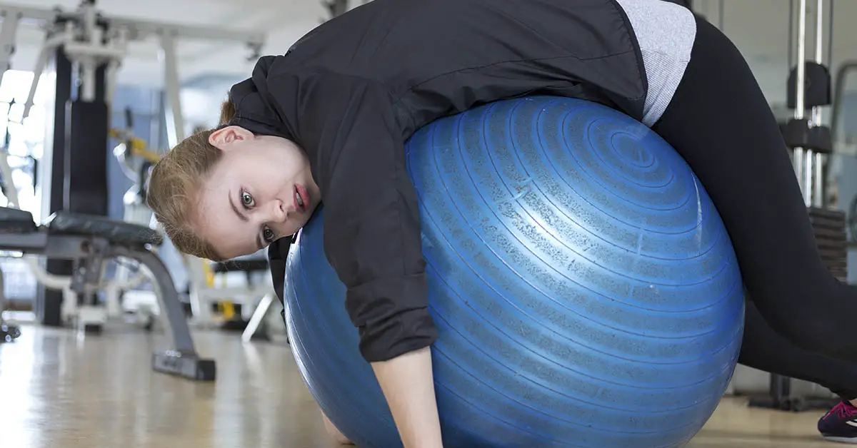 unmotivated woman on exercise ball