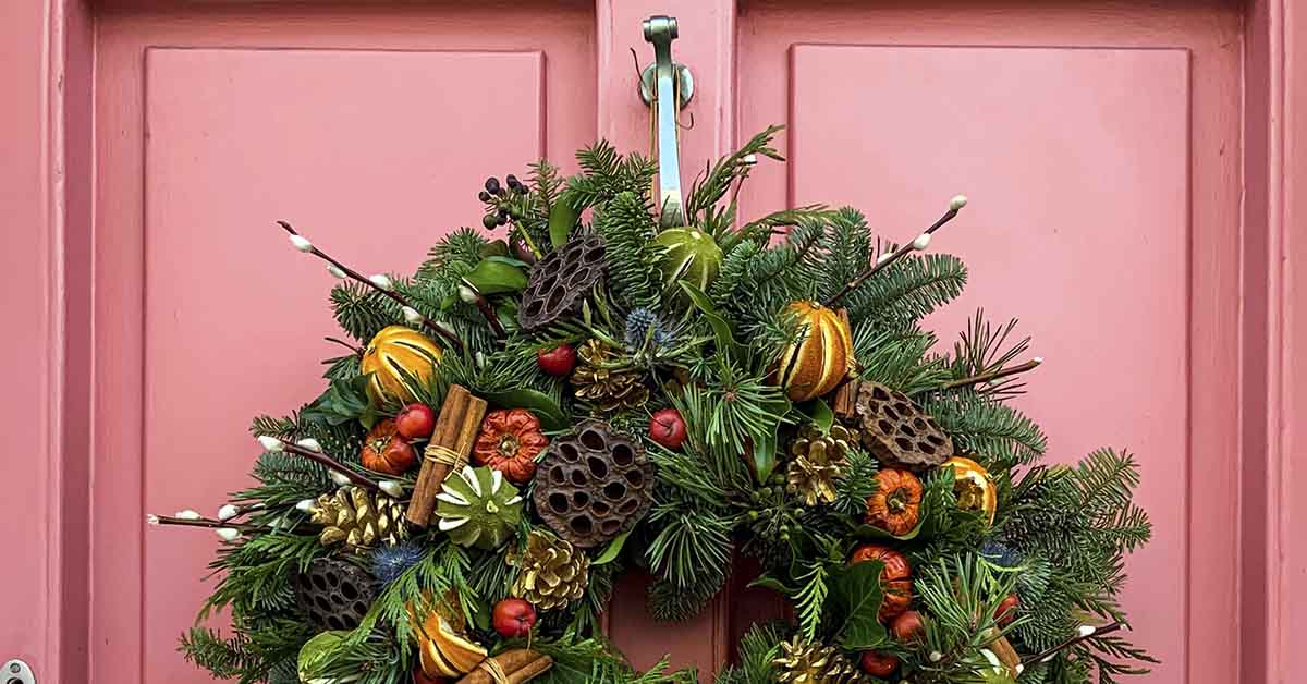 pink door with Christmas wreath