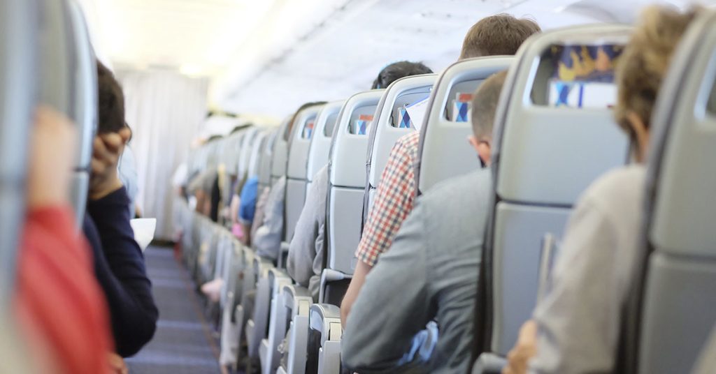 Flight Attendant Sits, Comforts Jittery Passenger in Touching Photo - Featured image