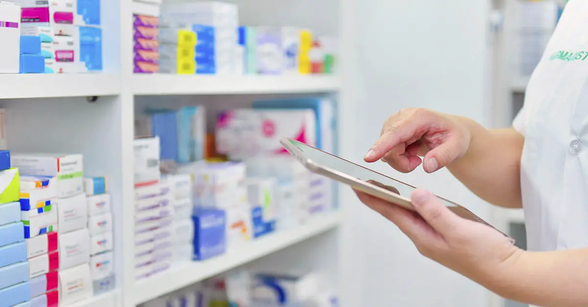 pharmacist assessing medications on shelf