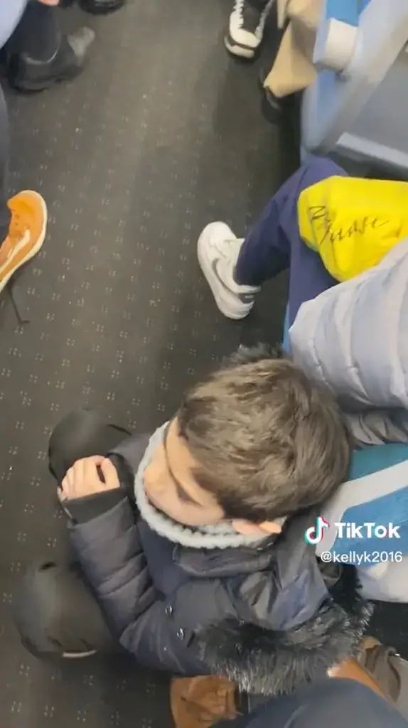 The clip showing the child seating on the floor after not getting a seat on a train.