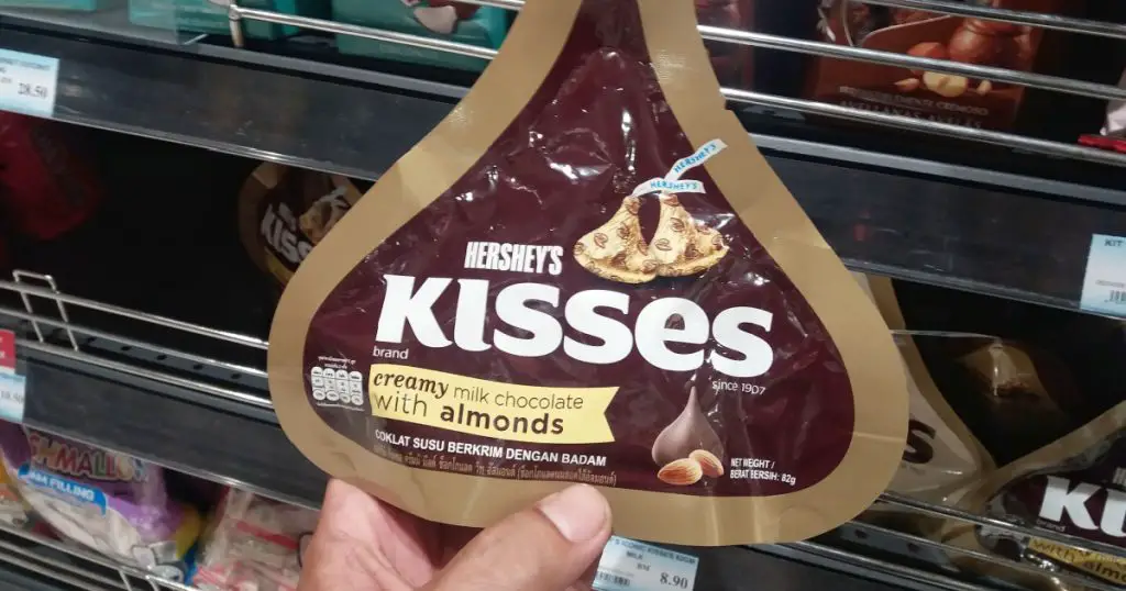 Kota Kemuning , Malaysia - 26 March 2018 : Hand hold a packet of HERSHEY'S Kisses creamy milk chocolate with almonds at the supermarket 
