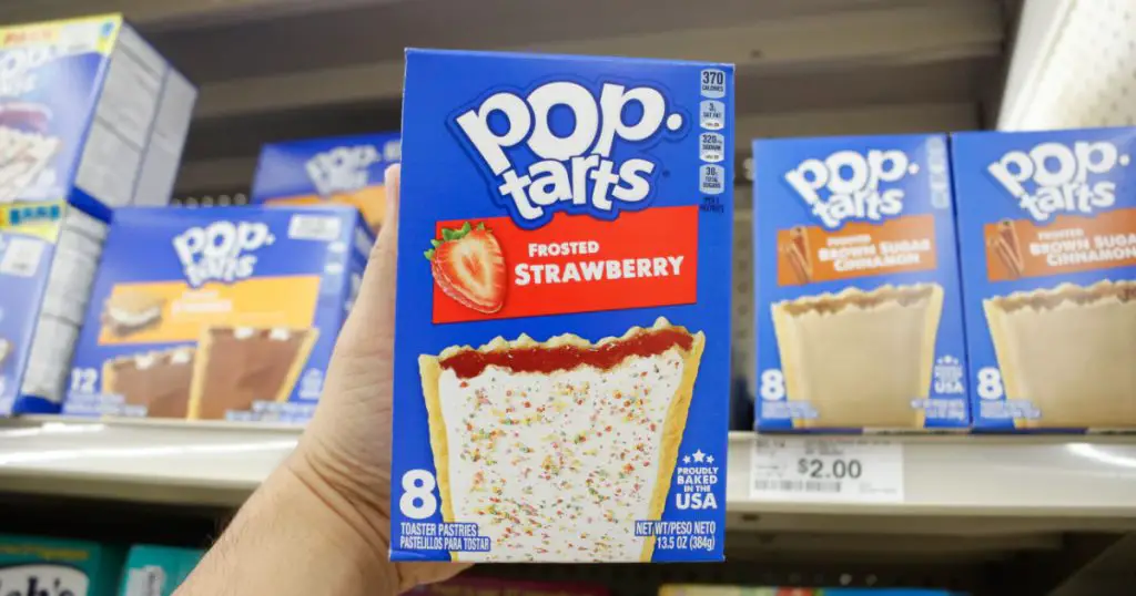 Los Angeles, California, United States - 02-12-2020: A view of a hand holding a box of Pop Tarts Frosted Strawberry, on display at a local grocery store.
