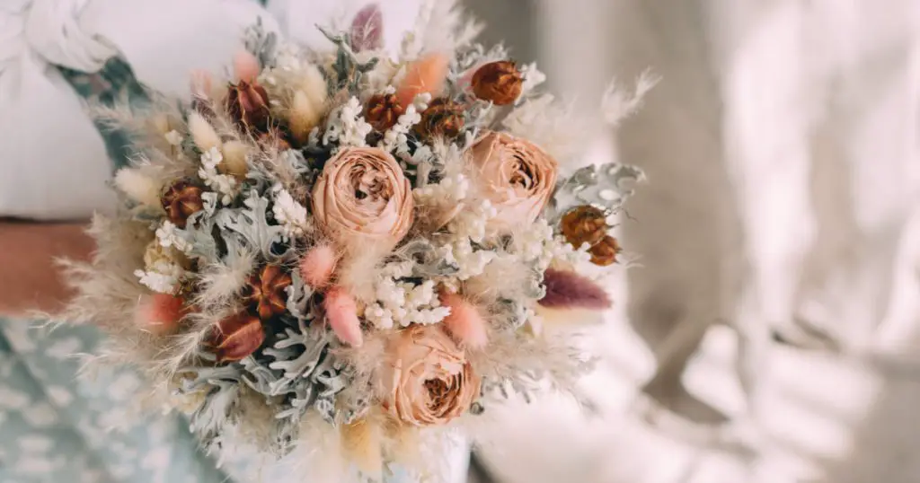 wedding bouquet of dried flowers in the hands of a florist
