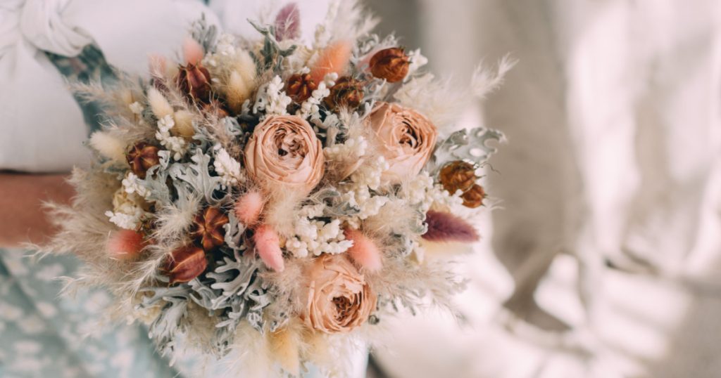 wedding bouquet of dried flowers in the hands of a florist