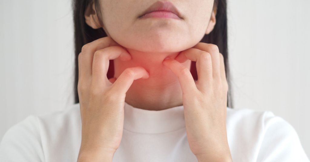 Asian woman scratching the itch on her neck with redness rash. cause of itchy skin include insect bites, dermatitis, fooddrugs allergies or dry skin. health care concept. closeup photo, blurred.
