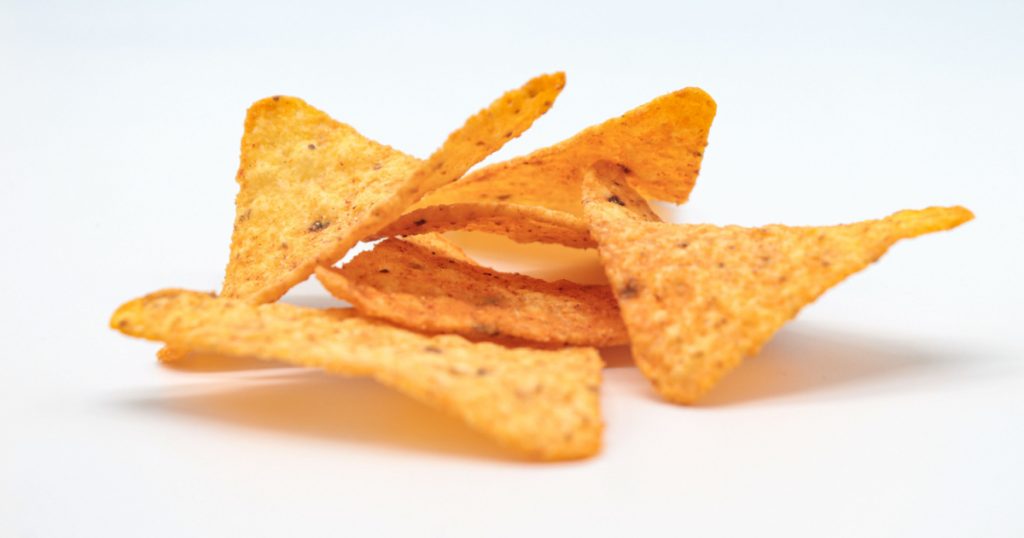 nachos chips isolated on white background. doritos triangle
