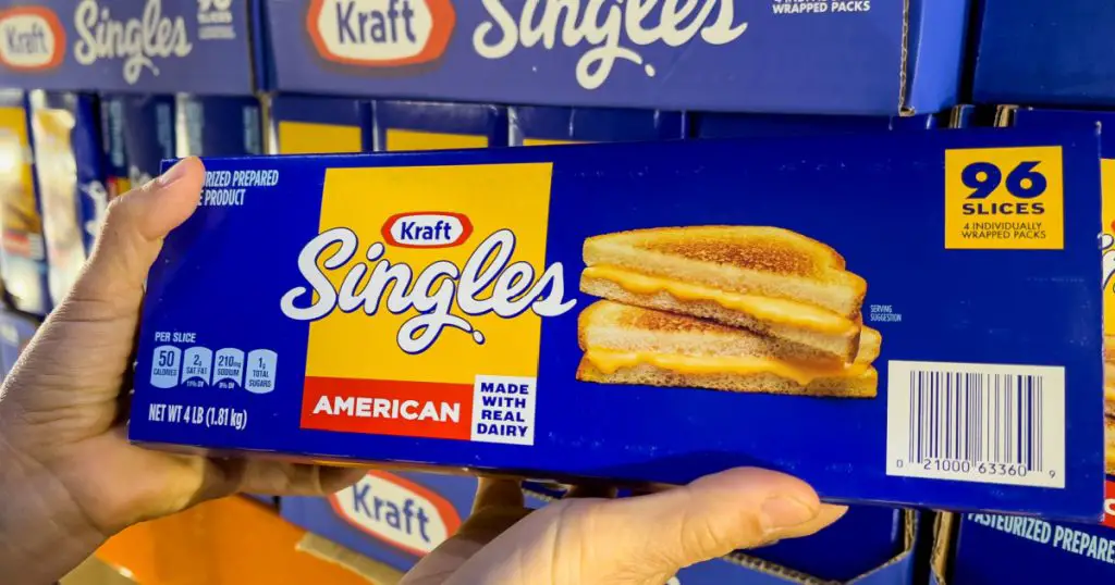 Sacramento, CA, USA September 14th 2023, shopper hands holding a family size package of Kraft's Singles Brand cheddar cheese slices at a local Costco Super store
