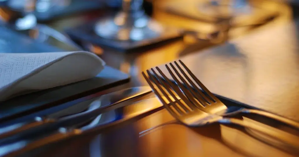 Table set for fine dining with cutlery and glassware
