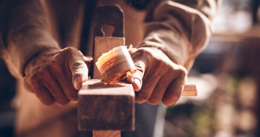 The carpenters are using spokeshave to decorate the woodwork.
