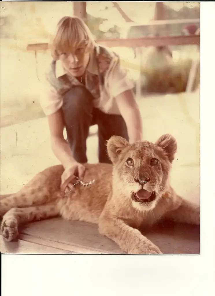 child posing with lion