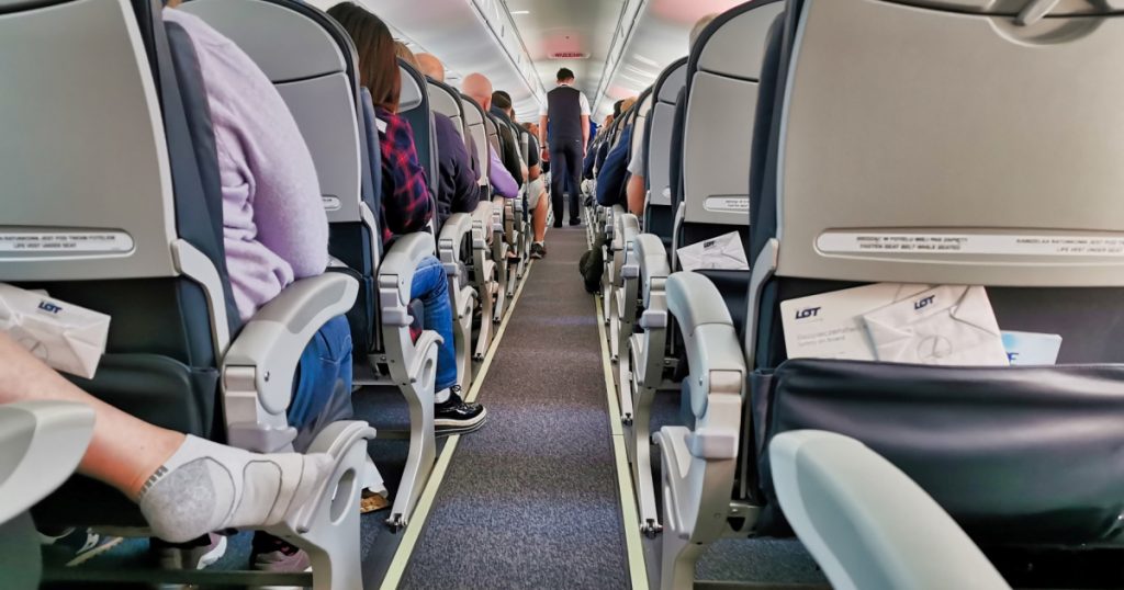 MUNICH / GERMANY - 09FEB2020: Low culture during flight. Passengers taking their shoes off - common unpleasant behaviour.
