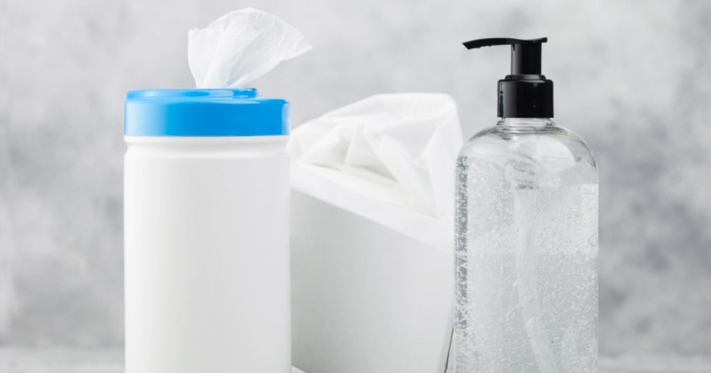 Plastic container with alcohol wipes with hand sanitizer plastic container and box of tissues on white background. Best protection from all viruses.
